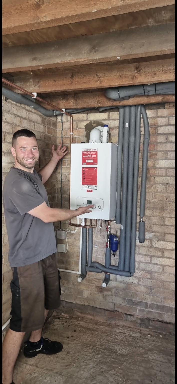 Luk from Luk Gas Ltd beside a completed Main boiler installation